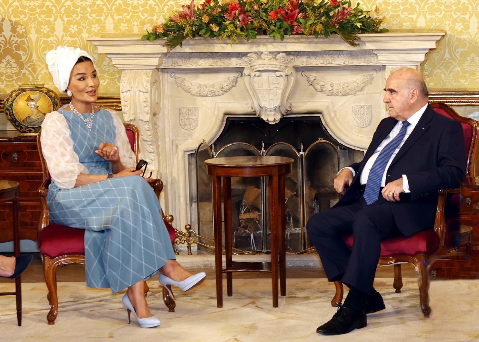 Sheikh Moza's appearance wearing a blue and white dress in Malta