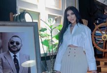 Dounia Batma next to a picture of King Mohammed VI