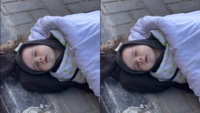 A baby lying on the ground in freezing cold weather