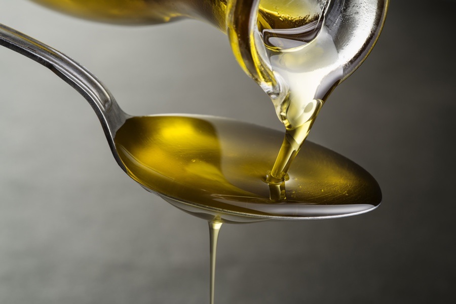 consume one or two tablespoons of olive oil on an empty stomach