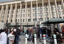 Syrians queue in front of the Central Bank in Damascus to exchange currencies, December 30, 2024.